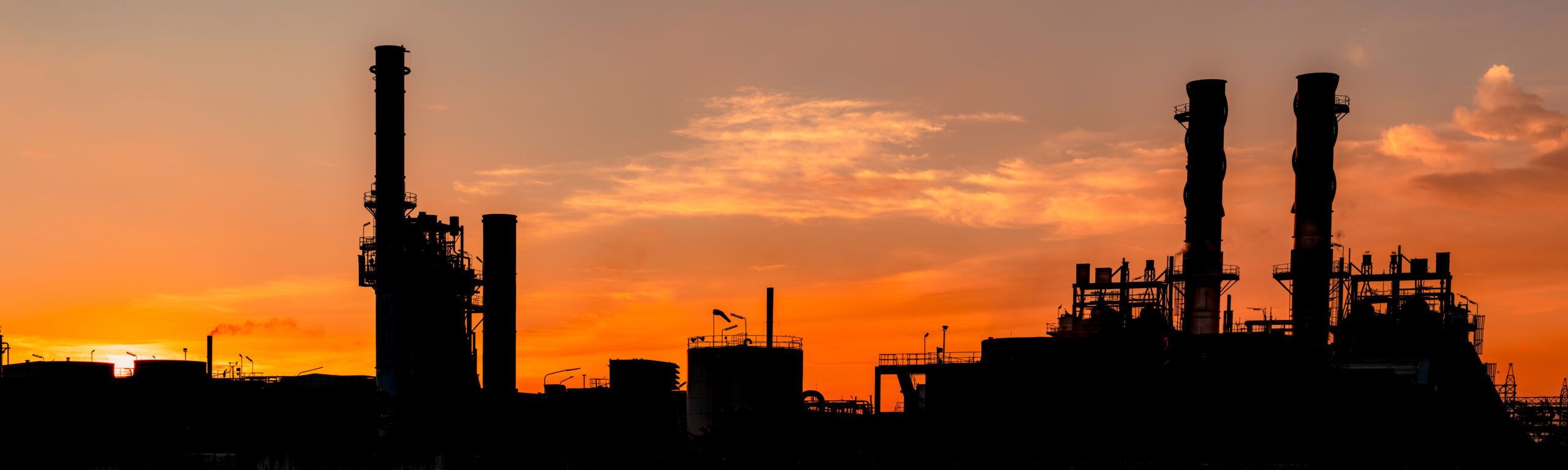 Gas turbine electrical power plant. Energy for support factory in industrial estate. Natural gas tank. Small gas power plant. Power plant using natural gas for fuel. Green energy. Dramatic sunset sky.